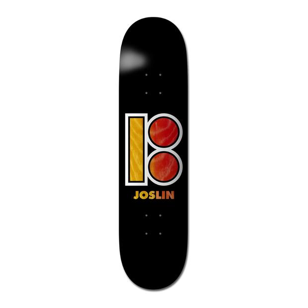 Plan B Joslin Black Out - Pro skateboard deck: Large Plan B logo of a rectangle and two circles with white outlines, filled in yellow and red-orange wood-grain texture, above the rider's name on a plain black deck.