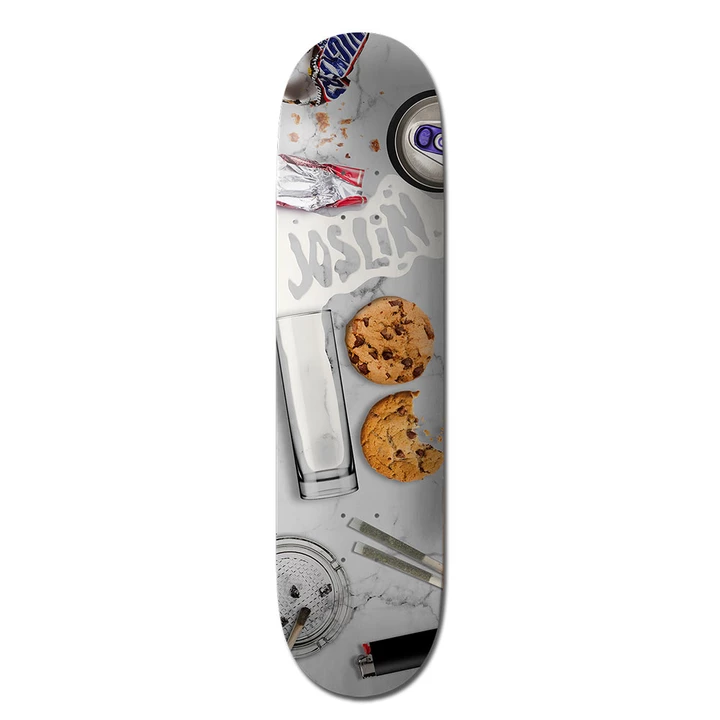 Plan B Joslin Milk N Cookies - Pro skateboard deck: A photographic top-down still life on grey marble: an empty milk glass, two chocolate chip cookies (one bitten), a spilt-milk 'Joslin' name, a chocolate bar wrapper, a can, an ashtray, joints and a lighter.