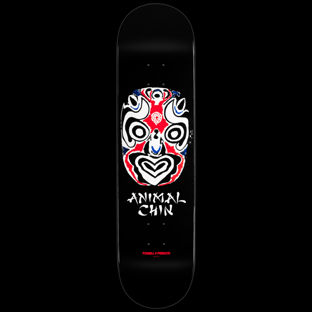 Powell Peralta Chin Mask Black skateboard deck: A stylised opera-style face mask in white, red and black with swirling concentric patterns, above 'Animal Chin' in brush lettering, on a plain black deck.