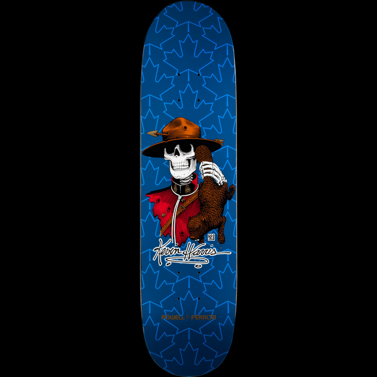 Powell Peralta Kevin Harris Mountie Navy skateboard deck: Royal blue deck with a pattern of darker maple leaves behind a skeleton in a red Mountie jacket and hat, holding a brown beaver, with a Kevin Harris signature.