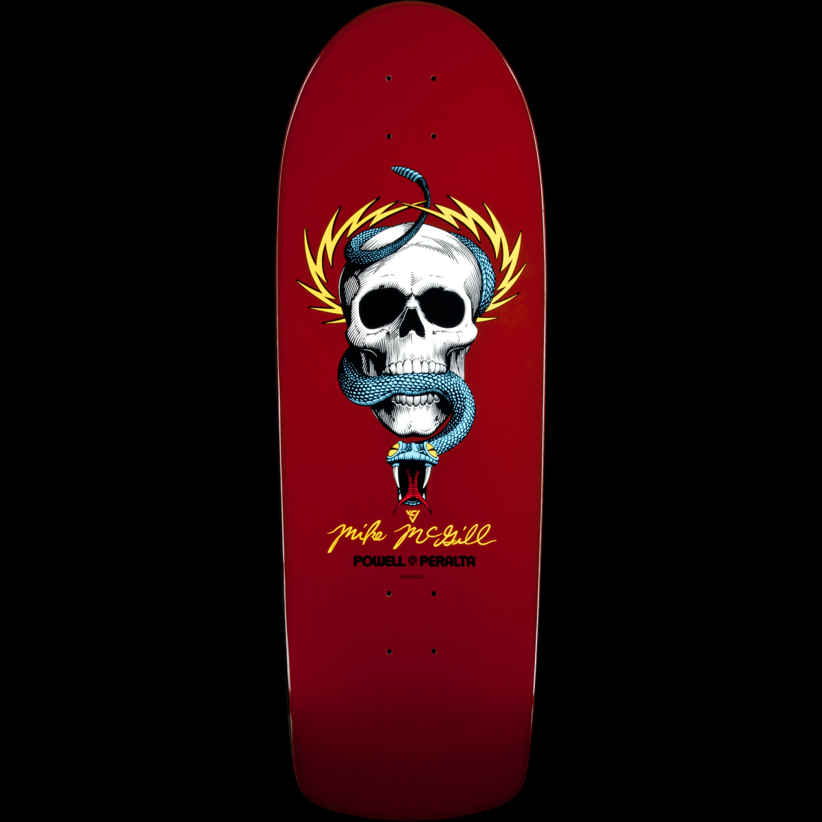 Powell Peralta Mike McGill Skull and Snake Burgundy skateboard deck: A detailed illustration of a white skull with a blue snake coiled around it, framed by yellow lightning bolts, on a burgundy deck. A yellow signature and the Powell Peralta logo sit beneath.