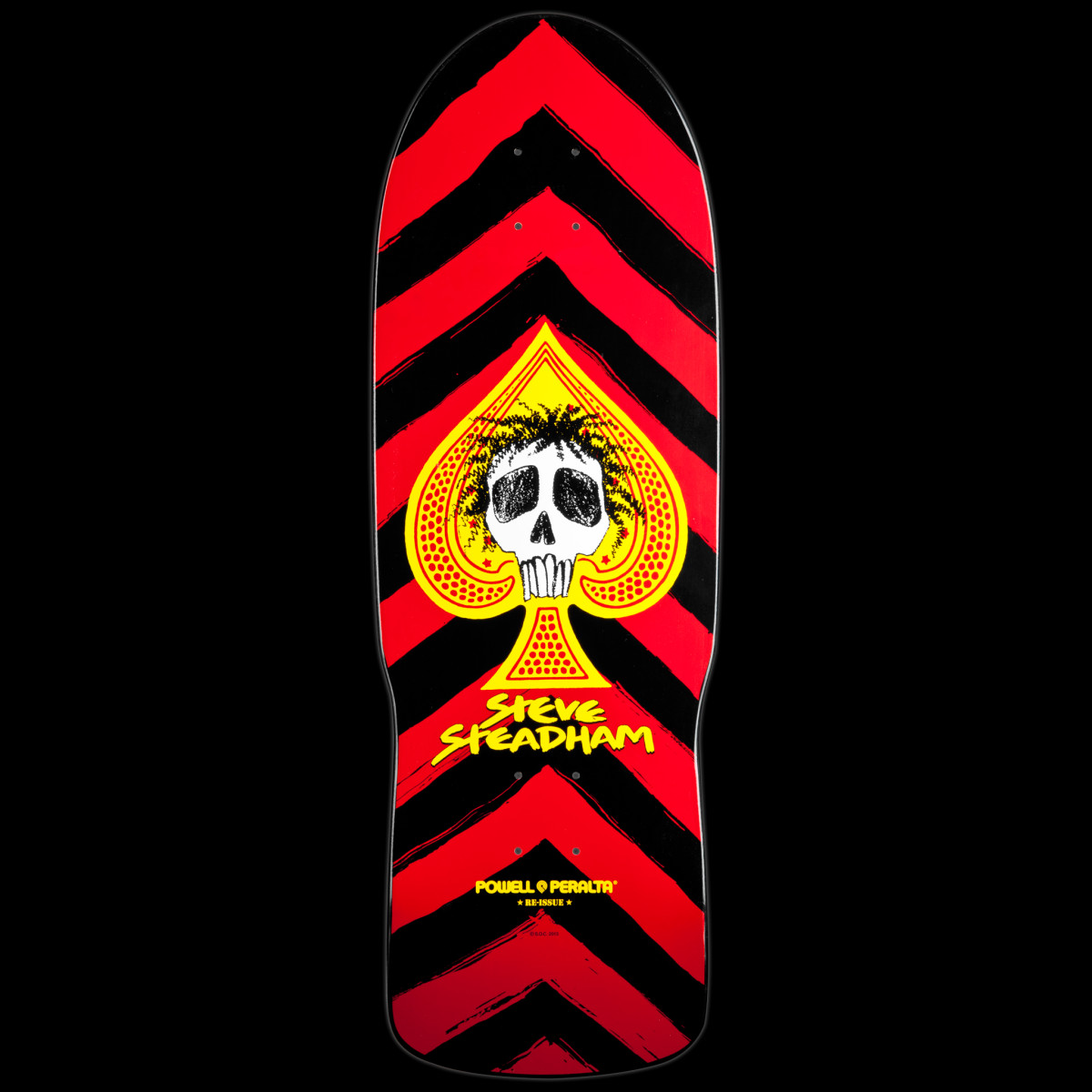 Powell Peralta Steadham Spade Red skateboard deck: A white skull with scruffy black hair sits inside a yellow spade, with Steve Steadham in yellow below, over bold red and black chevron stripes.
