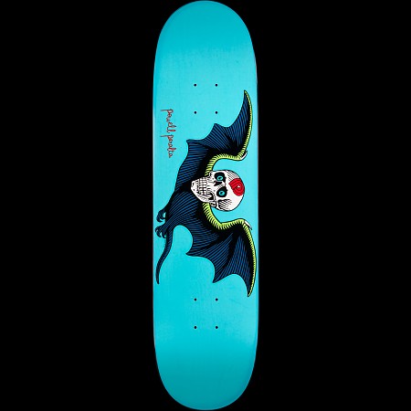 Powell Peralta Bat Skull Turquoise skateboard deck: White skull with teal eyes and a red mark on the forehead, held in a dark blue bat's wings edged in lime green, on a turquoise deck with a small red Powell Peralta signature.