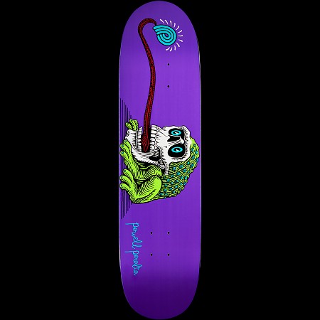 Powell Peralta Frog Skull skateboard deck: A green frog crouches inside a white skull, its long red tongue stretching up to a blue spiral lollipop-like swirl, on a purple deck. Powell Peralta signature in blue script near the tail.
