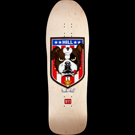 Powell Peralta Hill Bulldog skateboard deck: A shield with stars and red and white stripes holding a brown and white bulldog head with a bone on its brow and a sheriff star below. Signature beneath and a red 911 badge, on a natural maple old-school shaped deck.