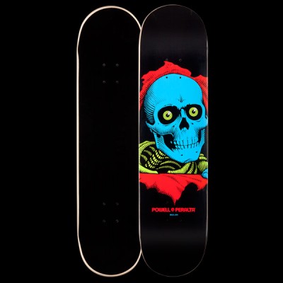 Powell Peralta BL Ripper 2 - Blacklight skateboard deck: Blue skull with yellow-green eyes bursting through a ripped red opening, with yellow-green ribs below, on a black deck. Red Powell Peralta text at the bottom; the plain black underside is shown beside it.
