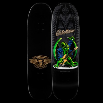 Powell Peralta Caballero Guitar - Black skateboard deck: A green dragon in a blue jacket plays a bass guitar on a round stage, with a large dark dragon head and spiked pattern behind it. Signature-style script name at the top; underside has a winged skull logo.