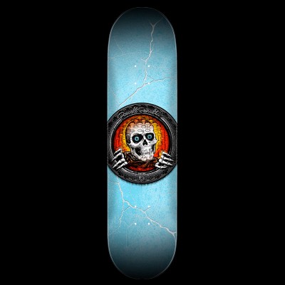 Powell Peralta Pool Light Ripper Red - Red skateboard deck: A skull with blue eyes and skeletal hands grips the rim of a round porthole-like frame, set against an orange glowing brick wall. The pale blue deck has white lightning cracks across it.