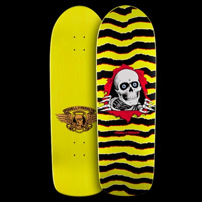 Powell Peralta Ripper - Yellow skateboard deck: Skull with blue eyes and skeletal hands tearing through a red ripped opening, set against jagged black and yellow zigzag stripes. Powell Peralta text below; the underside shows a winged skull logo on plain yellow. Both sides shown.