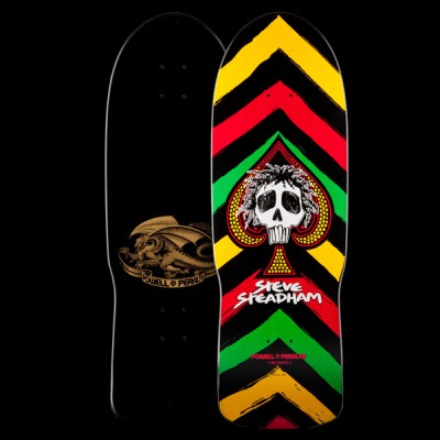Powell Peralta Steadham Spade - Rasta skateboard deck: Skull with wild dreadlocks inside a spade symbol, over bold brushstroke chevrons in yellow, red, green and black. Red Steve Steadham lettering below; the underside shows a gold dragon on black. Both sides shown.