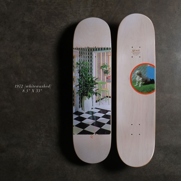 Quasi 19728.5 - Whitewashed Natural skateboard deck: Photograph of a room interior with a potted plant, patterned wallpaper, a green stool and a black and white chequered floor on a whitewashed natural wood deck. The underside shows a circled photo of a dog on grass.