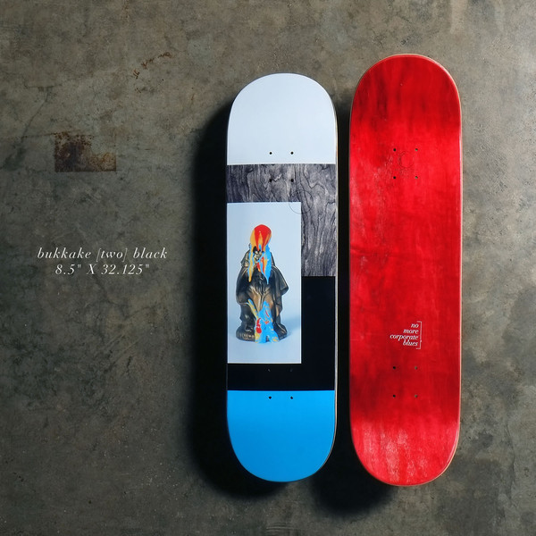 Quasi Bukkake - Black skateboard deck: Photographic collage: a small bright figurine in a dark robe on a pale panel, framed by grey wood-grain, black and pale grey blocks with a bright blue tail. The red-stained bottom face sits beside it with a small 'no more corporate blues' mark.