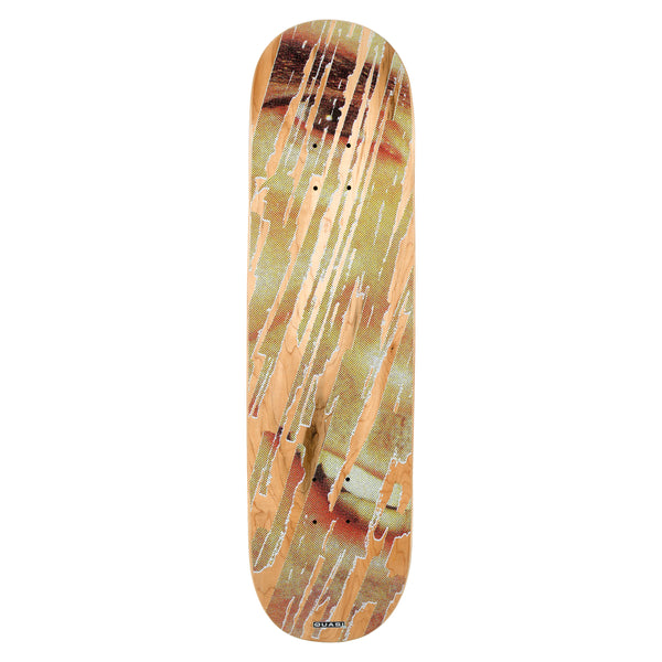 Quasi Erased skateboard deck: Enlarged halftone photo of an eye and face in warm brown and yellow tones, with vertical streaks scraped away to reveal the natural maple wood beneath. Small Quasi label at the tail.