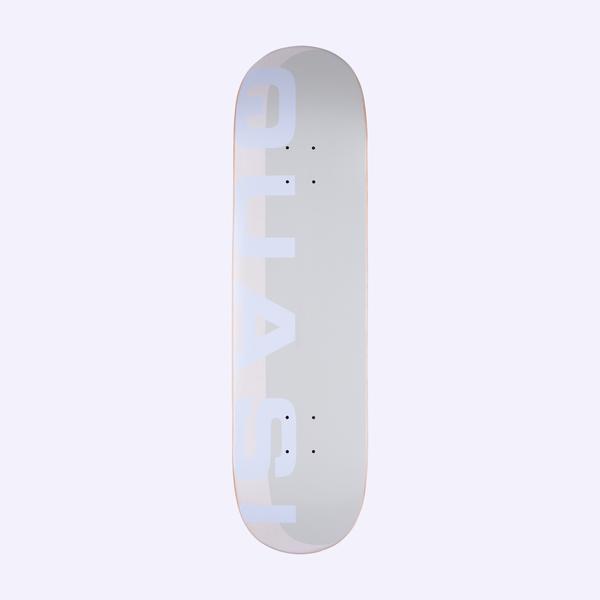 Quasi Mono Phade White skateboard deck: A pale grey and white deck with the Quasi name in large, pale lavender-white block capitals running vertically up the left side, with a faint shadow-like offset panel behind.