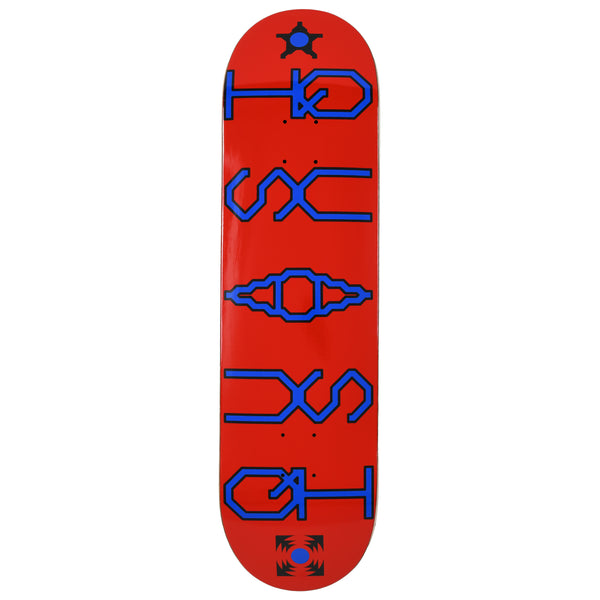 Quasi Unicode skateboard deck: Red deck with large blue outlined, angular pixel-style lettering running down the length, mirrored top and bottom around a central ornamental glyph. Small black star and burst symbols sit at each end.