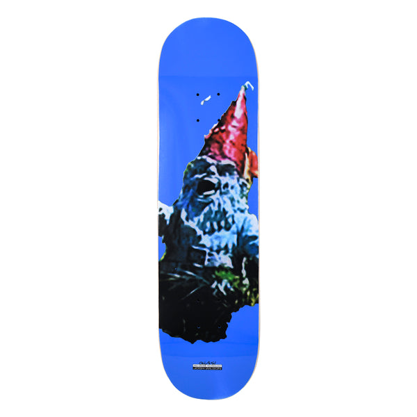 Quasi Wilson Pro Gnome skateboard deck: Photographic close-up of a weathered garden gnome with a red pointed hat, cut out against a flat bright blue deck, with a small Quasi label and rider name near the tail.