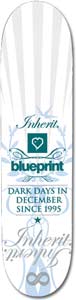 Blueprint Cursive White skateboard deck: White deck with pale grey radiating stripes and ornate blue scrollwork. Script lettering, a teal heart logo box, the Blueprint name and a slogan sit centrally, with a large faded script word and infinity symbol near the tail.
