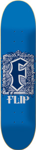 Flip Cryptic Logo skateboard deck: Large blackletter 'F' in navy and white inside an ornate decorative frame of scrolls and foliage, with 'FLIP' beneath, on a plain blue deck.