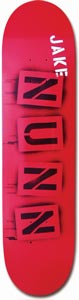Think Nunn Aerosol skateboard deck: Red deck with the rider's surname NUN spelt out in four stencilled black letter blocks stacked down the board, with JAKE in white capitals near the nose and spray marks behind.