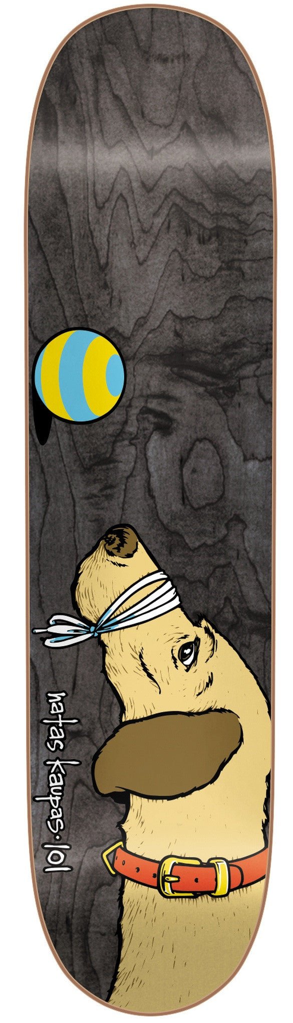 101 Heritage Natas Dog Sp skateboard deck: Grey wood-grain deck with a cartoon dog with a blindfold and orange collar looking up at a blue and yellow striped ball. Natas Kaupas 101 written along the side.