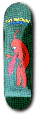 Toy Machine Templeton Barfer skateboard deck: Cartoon red creature with one eye and a curled antenna vomiting pink matter, against a green tiled background. 'Toy Machine' and 'Ed Templeton' arch across the top in yellow and blue lettering.