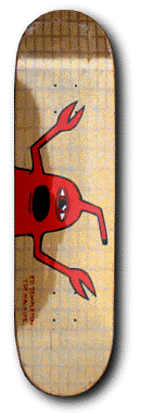 Unknown Templeton Jesus skateboard deck: Red cartoon monster with a black open mouth, a single eye and two long clawed arms reaching across a gold deck with a faint grid texture. Tiny red text sits along the lower edge.