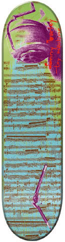 Toy Machine Donnny Barley Composition skateboard deck: A pink and purple desk-lamp-like object at the top over a blue and green background printed with sheet music, with a purple pen-like line near the bottom and handwritten text in red.