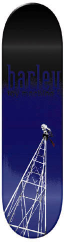 Toy Machine Donnny Barley Windmill skateboard deck: A tall white lattice windmill tower with a small figure at its top rises from the base of a deck fading from black to deep blue. The rider's surname is in large blue lowercase text near the top with small text beneath.