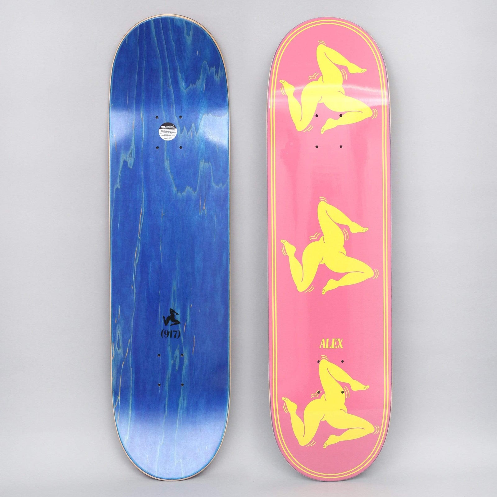 917 17 8.38 Alex Legs Pink skateboard deck: Three yellow naked three-legged figures, in the triskelion style, stacked down a pink deck within a thin yellow double border, with ALEX near the tail. The blue underside has a small figure and (917).