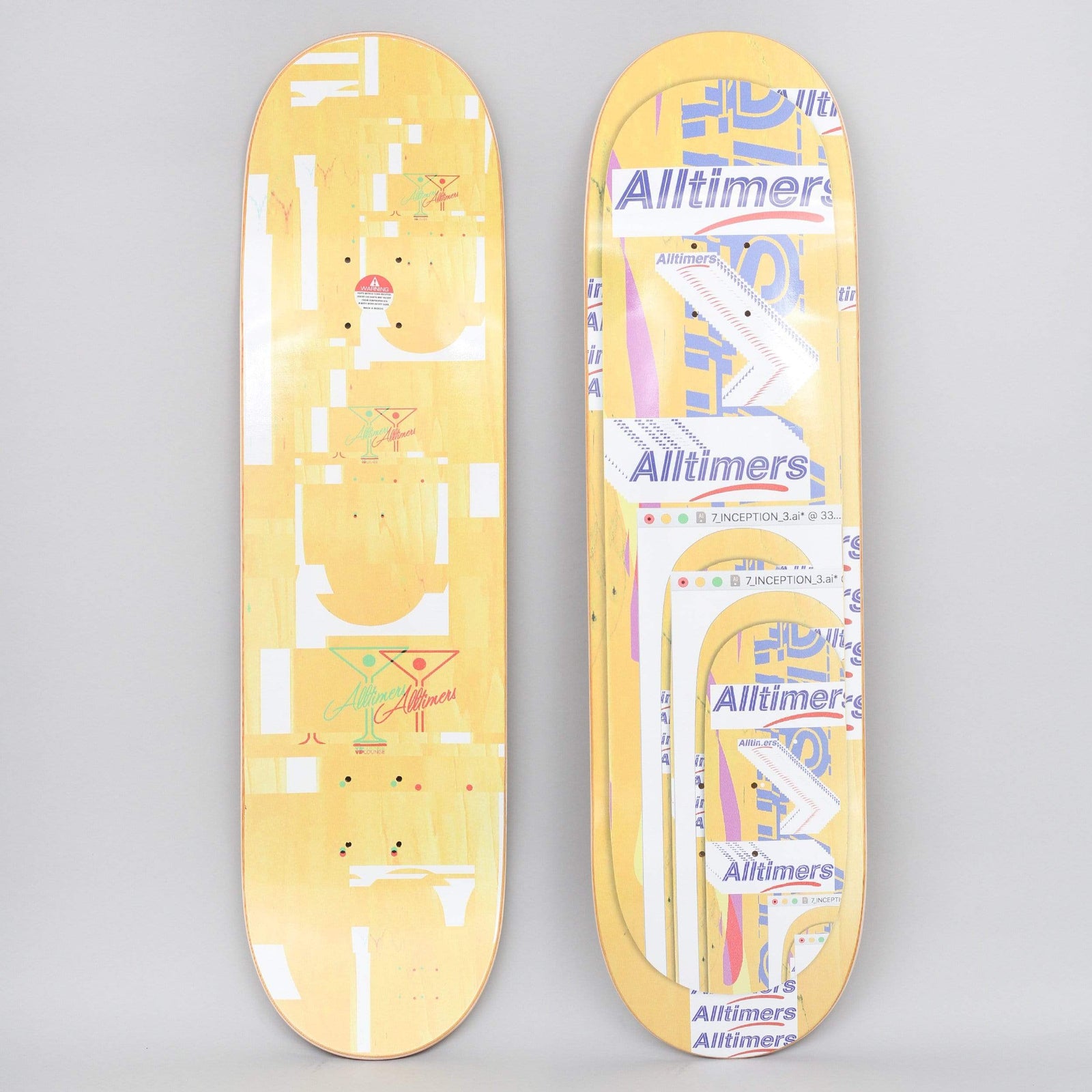 Alltimers Glitch Yellow skateboard deck: Glitchy digital collage of overlapping Alltimers logos, window title bars and cut-out shapes in white and blue-purple on a yellow-stained deck, with martini glass logos on the underside.