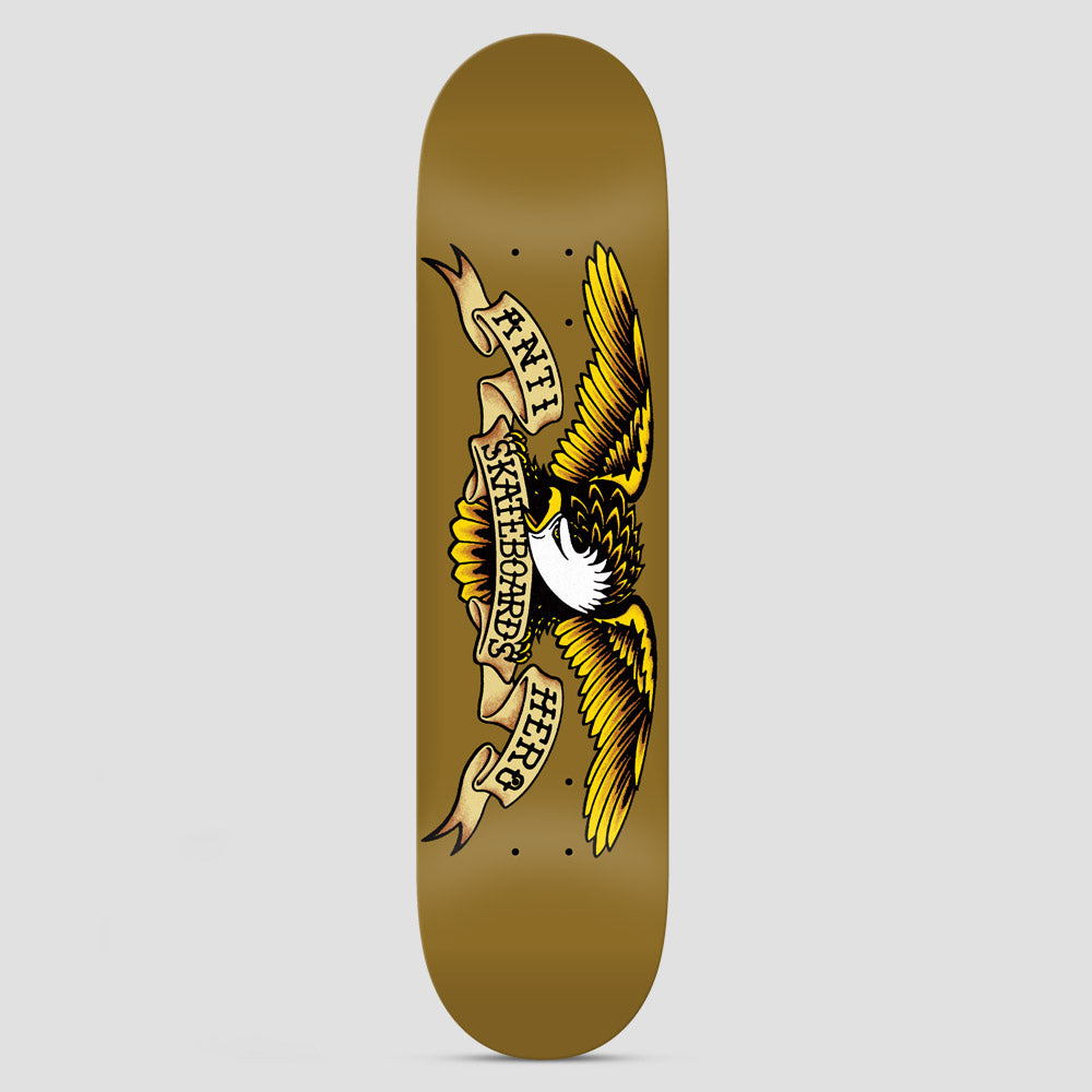 Anti Hero Classic Eagle Brown skateboard deck: The classic Anti Hero eagle in yellow, black and white, wings spread, clutching a scroll banner with the brand name, on a plain brown deck. Traditional tattoo-flash style.
