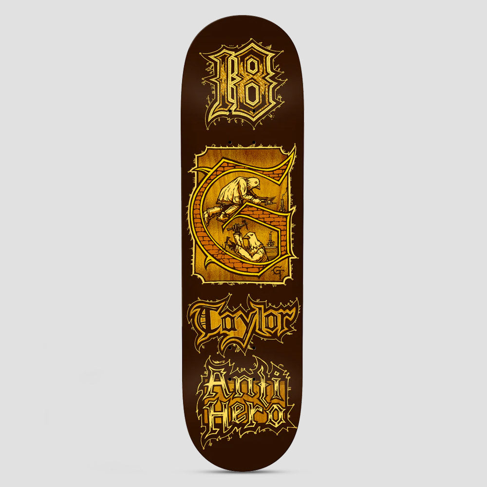 Anti Hero Grant Medieval Brown skateboard deck: Illuminated manuscript style design in gold on brown: a blackletter 18, a decorated G initial containing two pigeons building a brick wall, then the rider surname and Anti Hero in gothic lettering.