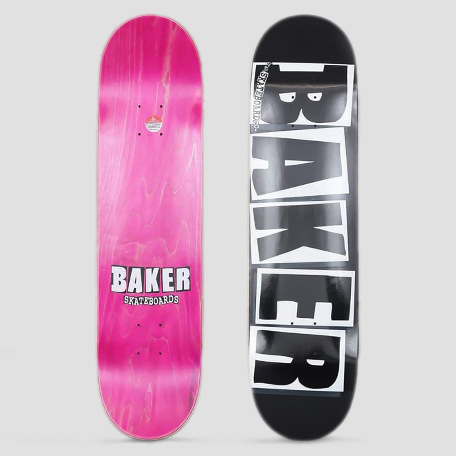 Baker Logo Black / White skateboard deck: Large white block letters spelling BAKER, framed in white boxes, run vertically down a black deck; the small Skateboards text reads along the left edge. The photo also shows the pink-stained underside with a small logo.