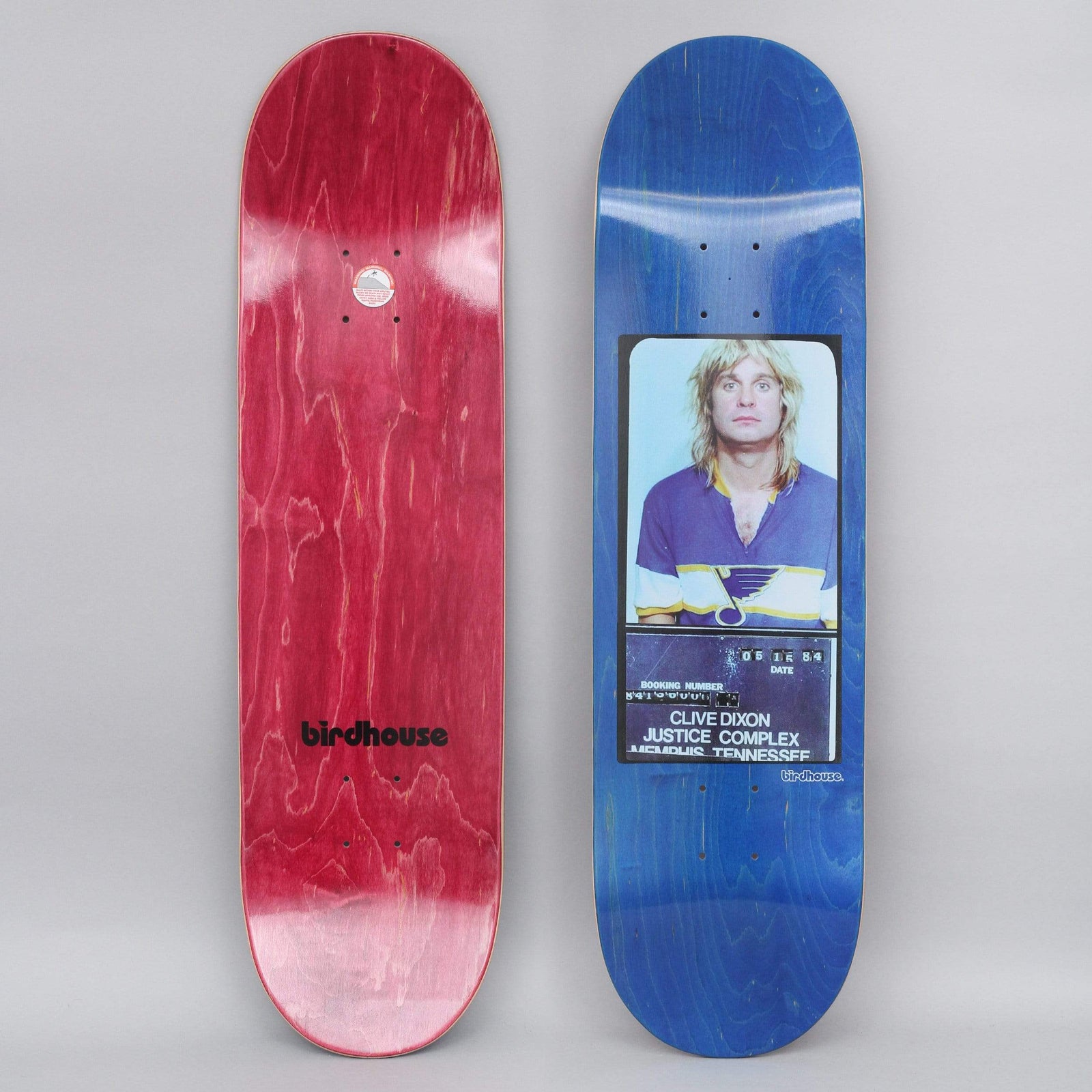 Birdhouse Dixon Mugshot skateboard deck: Colour mugshot of a long-haired blond man in a purple St. Louis Blues hockey jersey, with a booking board reading Clive Dixon, Justice Complex, Memphis, Tennessee, on a blue stained deck.