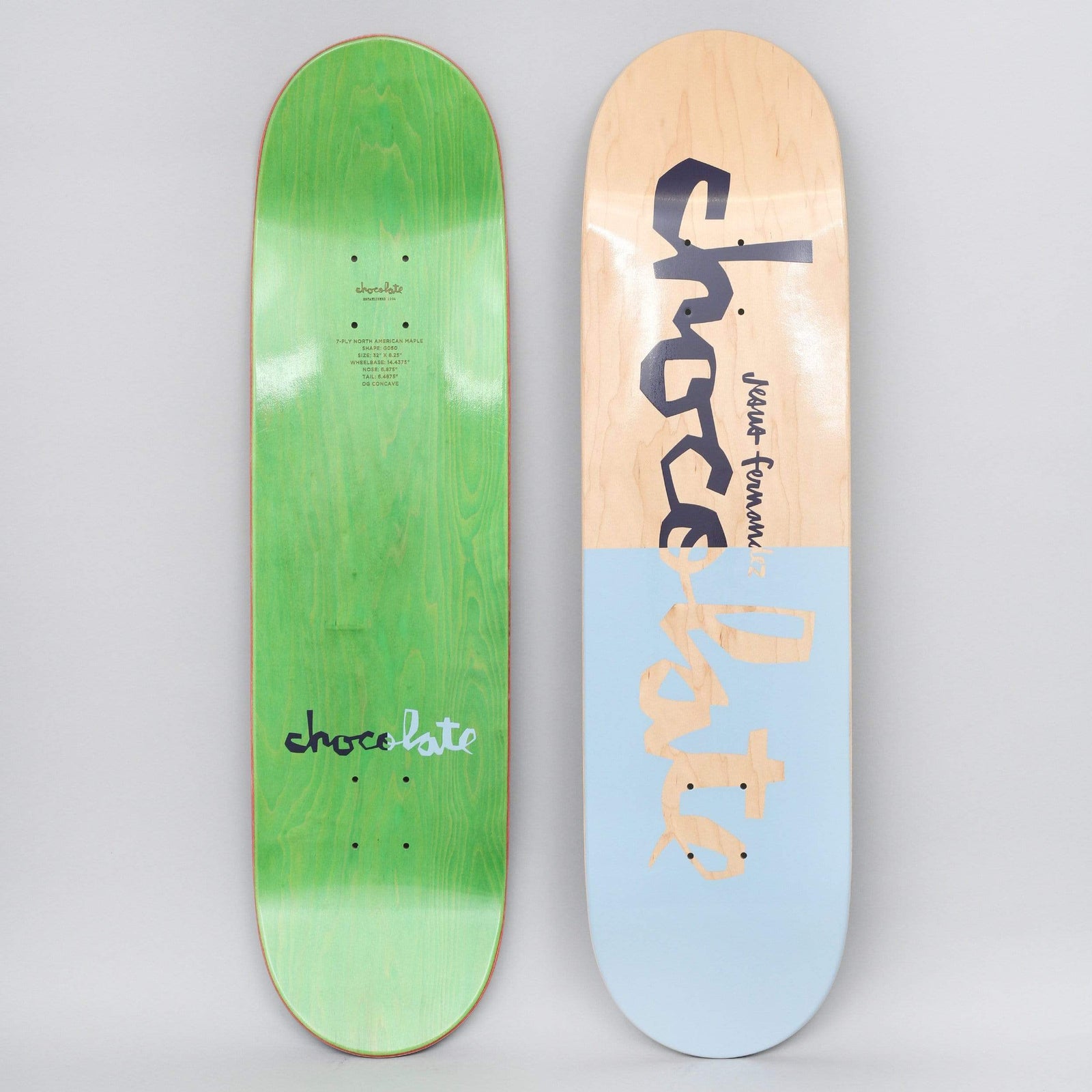 Chocolate Jesus Fernandez Original Chunk Natural / Blue skateboard deck: Large hand-lettered Chocolate 'chunk' logo in navy across the top half on bare natural maple, while the lower half is a pale blue block with the lettering showing through in wood tone. A rider name is written small beside the logo.