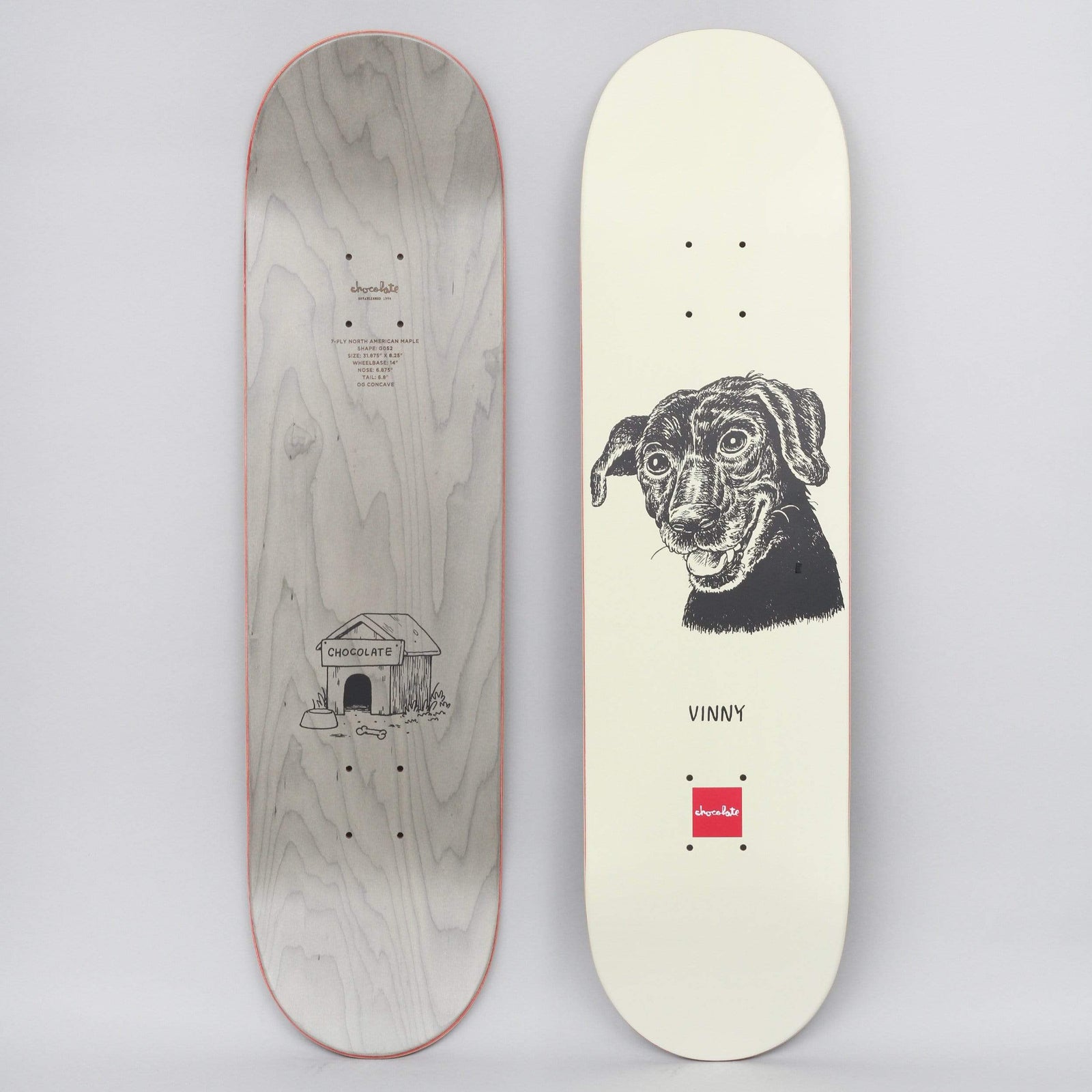 Chocolate Vincent Alvarez Big Dawg Cream skateboard deck: Black ink portrait of a smiling dog with floppy ears on a cream deck, with a name below and a small red brand square at the tail. The underside shows a doghouse drawing on grey stain.