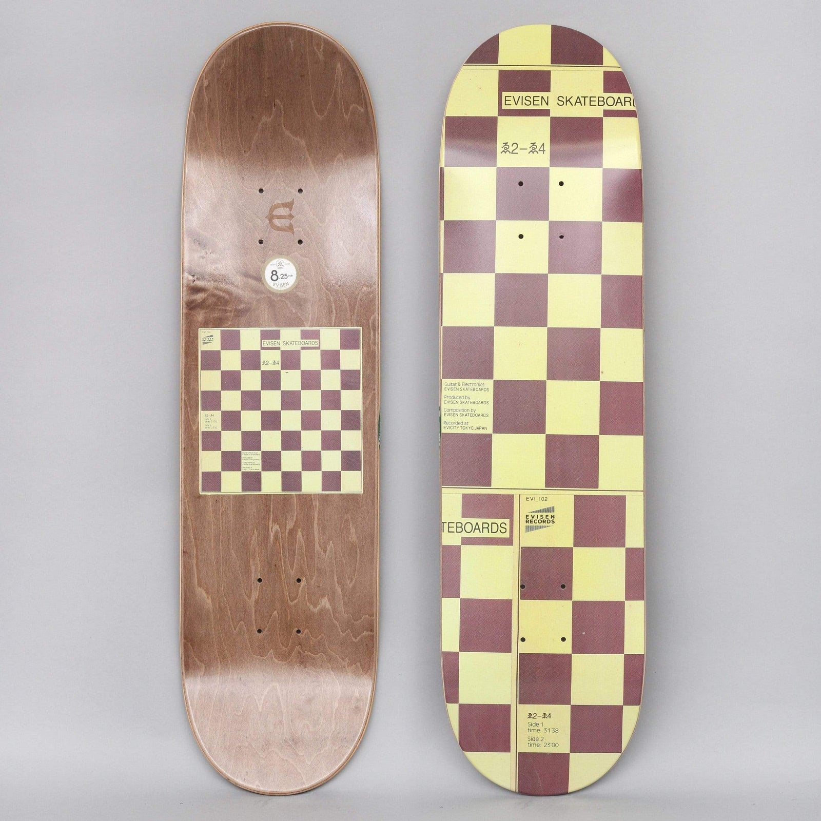 Evisen WYE2 - WYE4 skateboard deck: Cream and maroon chequerboard pattern covering the deck, styled like a record sleeve with small print, a catalogue number and an Evisen Records mark. The brown underside with a smaller board graphic is shown alongside.