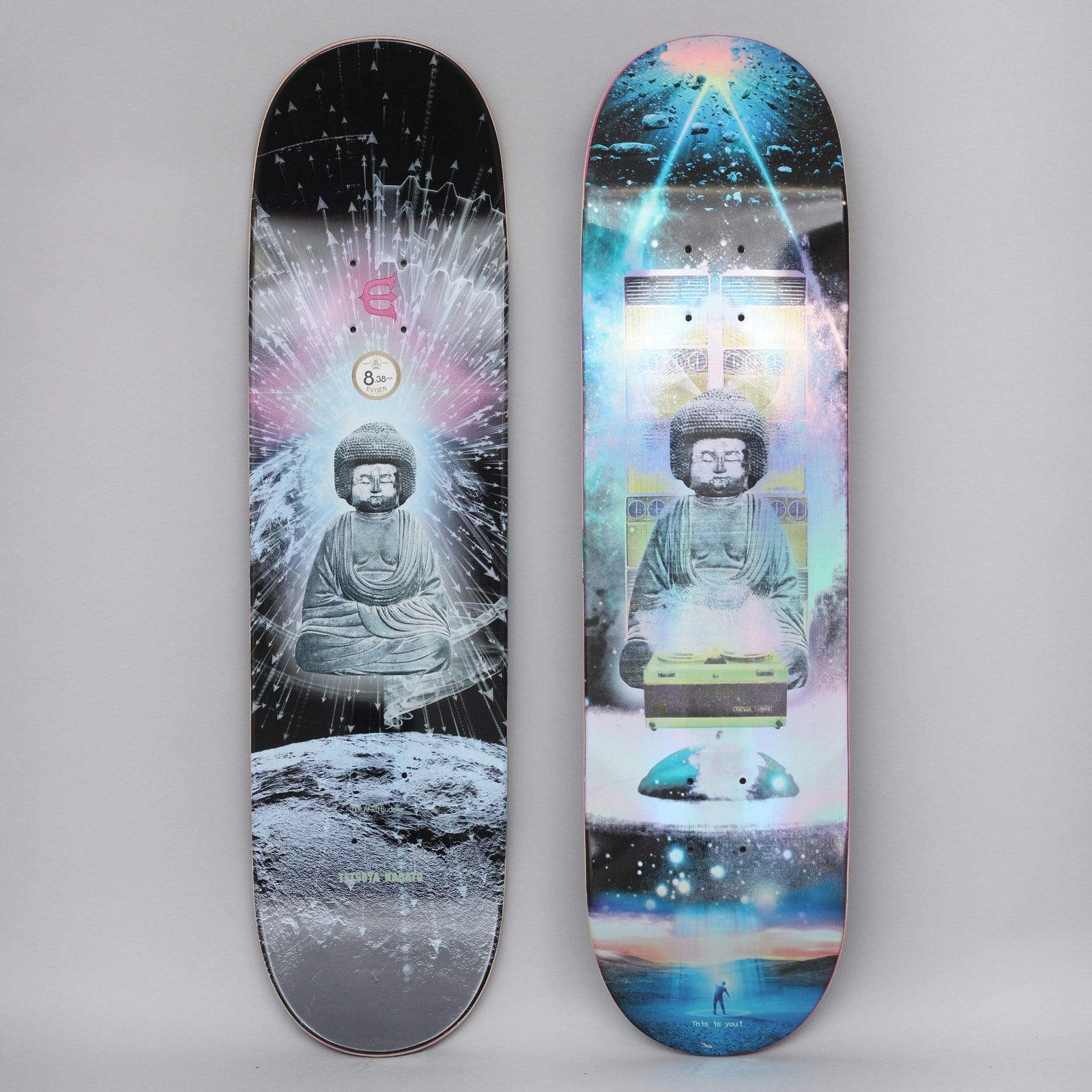 Evisen DJ Afro Buddha skateboard deck: A grey stone Buddha statue with an afro-style hair sits behind a record deck in a cosmic scene with moon, galaxy and light beams. The top shows a holographic, colourful version and the underside a black and white one with an Evisen logo.