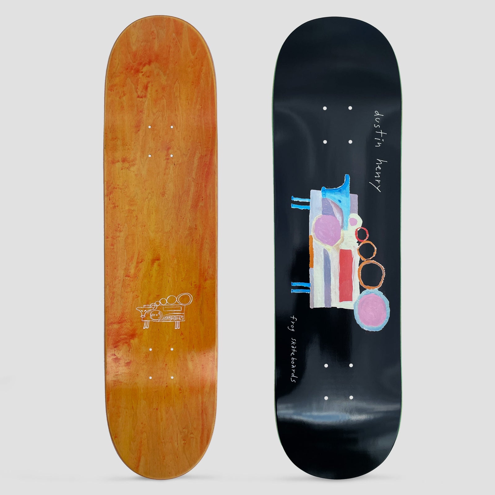 Frog Dustin Henry Painted Cow skateboard deck: Naive painted cow made of pastel blocks, circles and rings in pink, blue, red and orange, with blue legs and a head, on a black deck. Handwritten white text names the rider and brand.