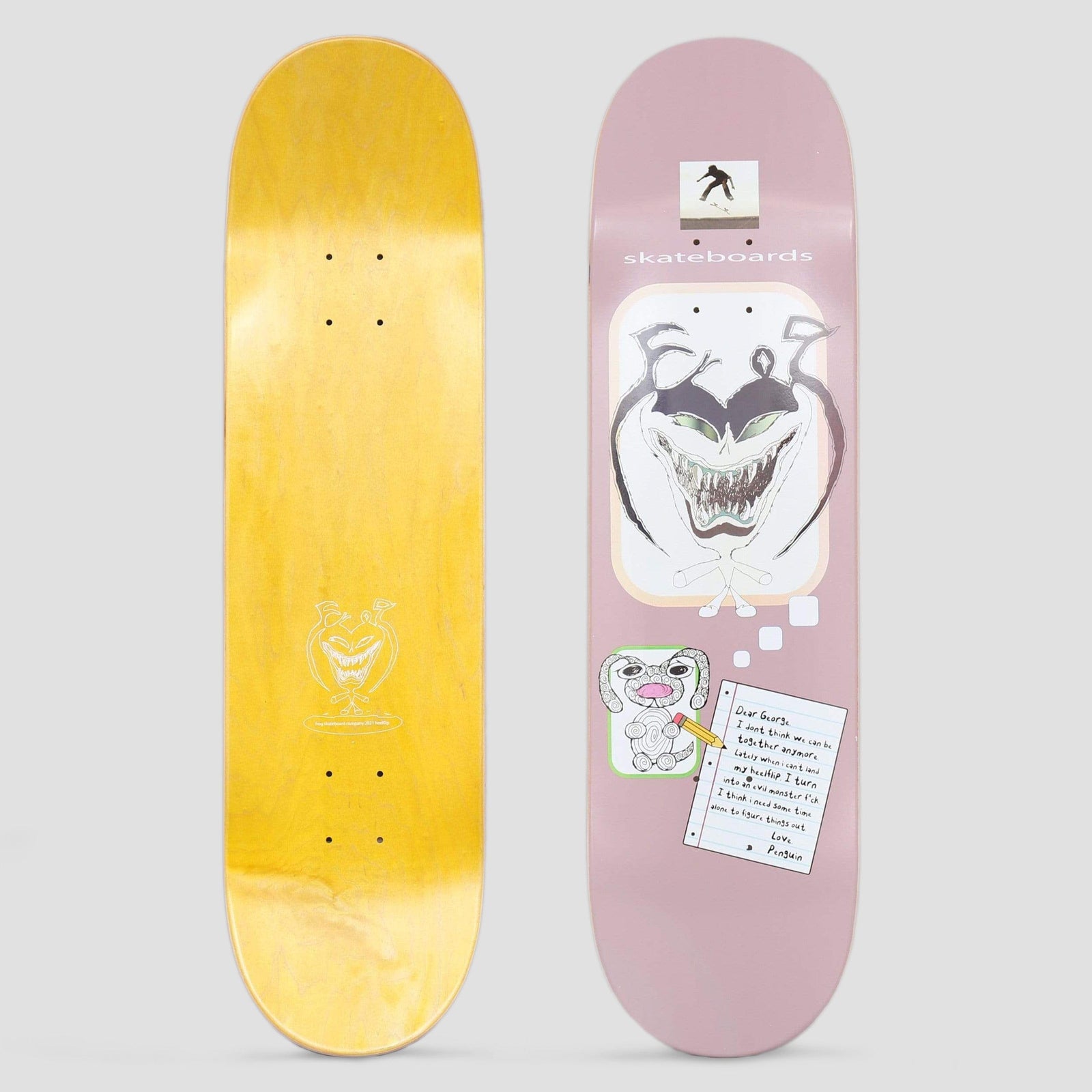 Frog Dear George Mauve skateboard deck: Mauve deck with a rounded panel containing a grinning, toothy monster face with horns, plus a small drawing of a floppy-eared dog and a handwritten lined-paper note signed Penguin. A small skater photo sits at the top.