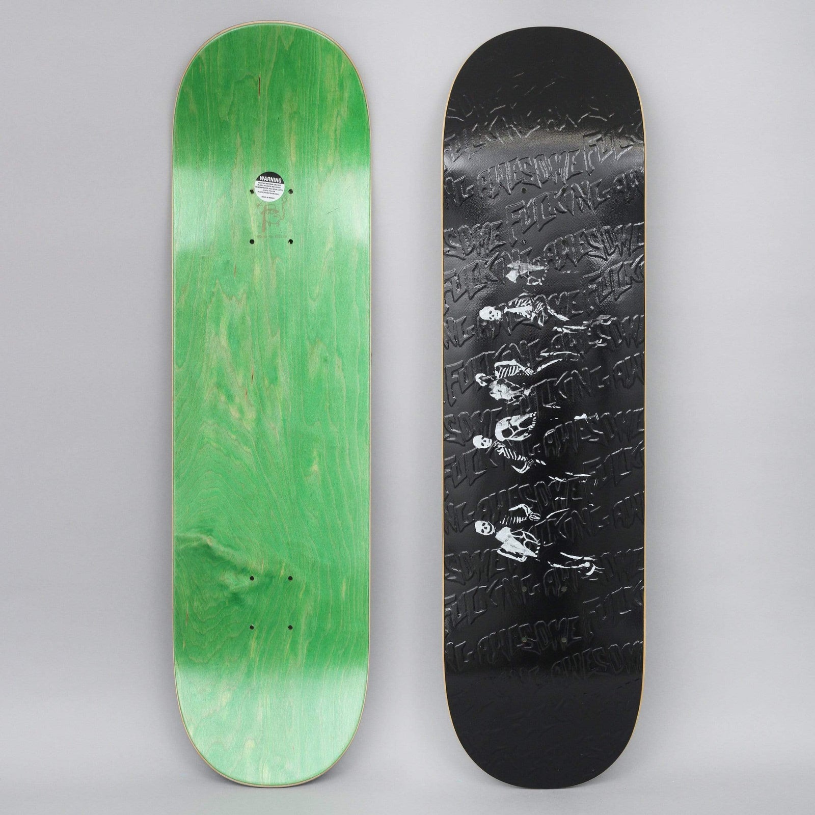 Fucking Awesome Four Horseman Slick Black skateboard deck: Glossy black deck with a repeating embossed Fucking Awesome logo pattern. A line of four small white skeleton figures on horseback runs across the middle.