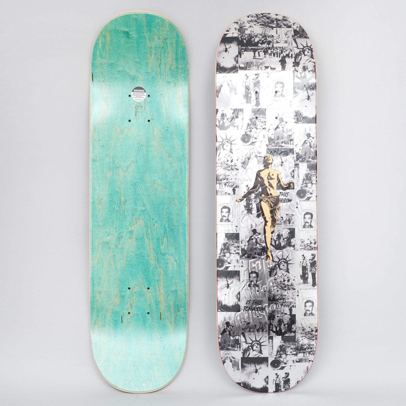 Fucking Awesome Running skateboard deck: A black and white collage of newspaper-style photos, including the Statue of Liberty, portraits and crowds, with a gold classical figure running across the centre. The photo also shows the teal-stained underside.