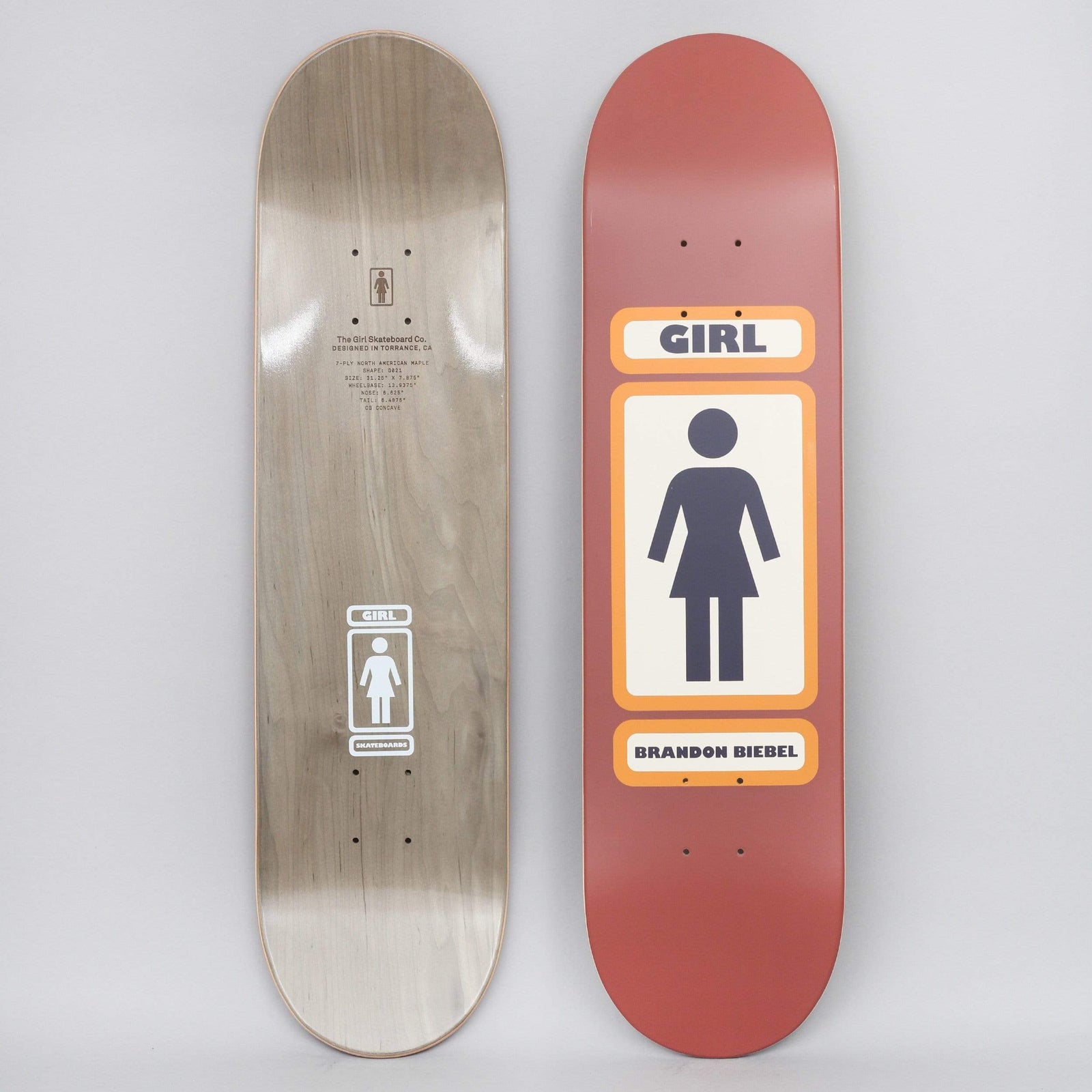 Girl Brandon Biebel 93 Til Brown skateboard deck: Girl's figure logo in a cream panel with orange borders, with the Girl name in a panel above and the rider's name below, on a rust red deck. The photo shows the bottom face too.