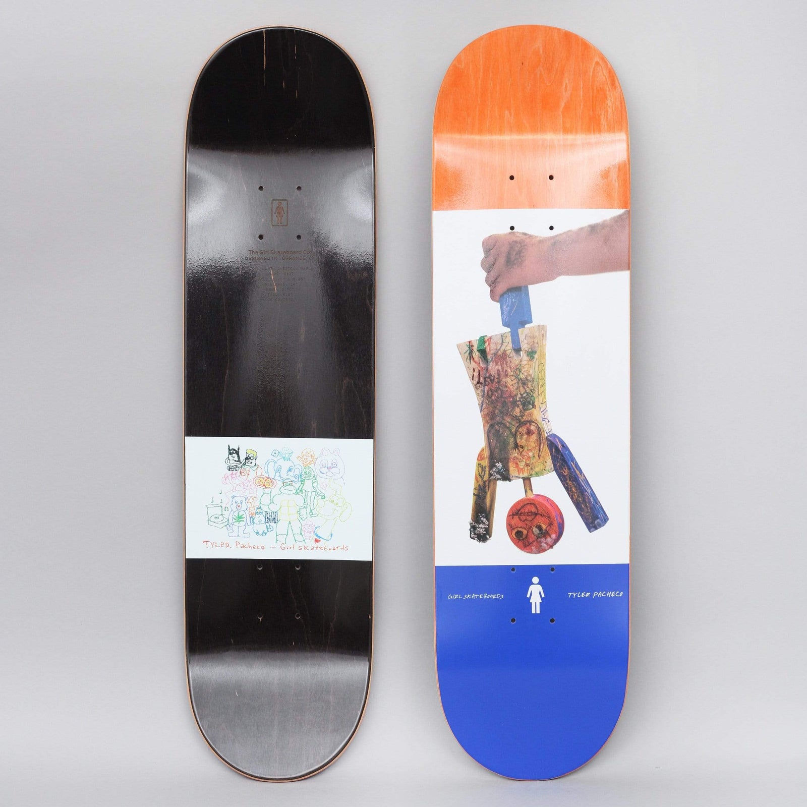 Girl Tyler Pacheco One Off skateboard deck: Photo collage on a white panel of a tattooed hand holding a scruffy handmade object made of scrawled-on wood pieces with a red wheel, between an orange top and blue bottom band. The underside shows a small coloured-pencil drawing of animal characters.