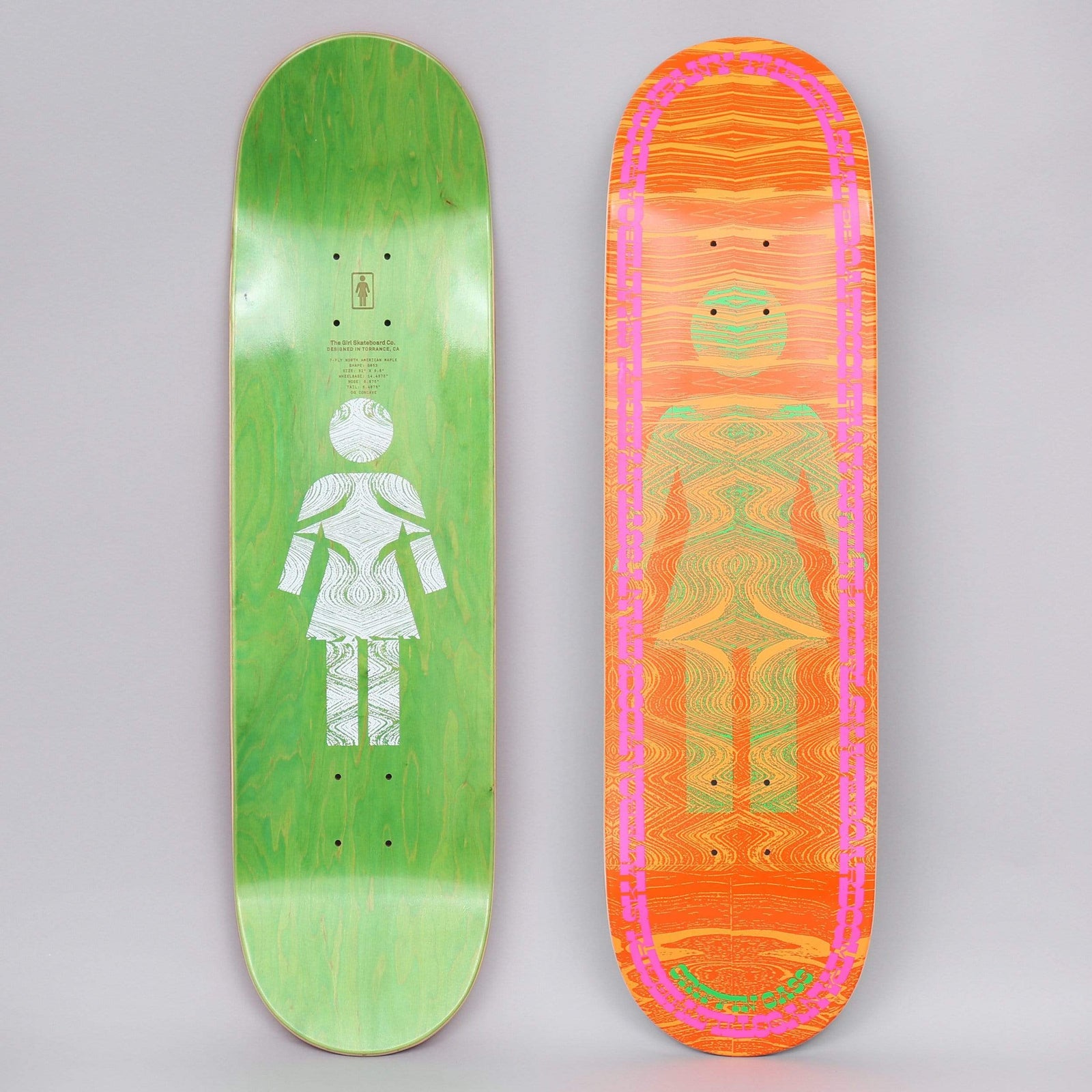 Girl Griffin Gass Vibrations OG skateboard deck: Girl's OG woman-symbol silhouette filled with a rippling, vibrating wood-grain pattern in green and orange, inside a pink dashed oval border. Orange background; the green underside carries a white version of the figure.