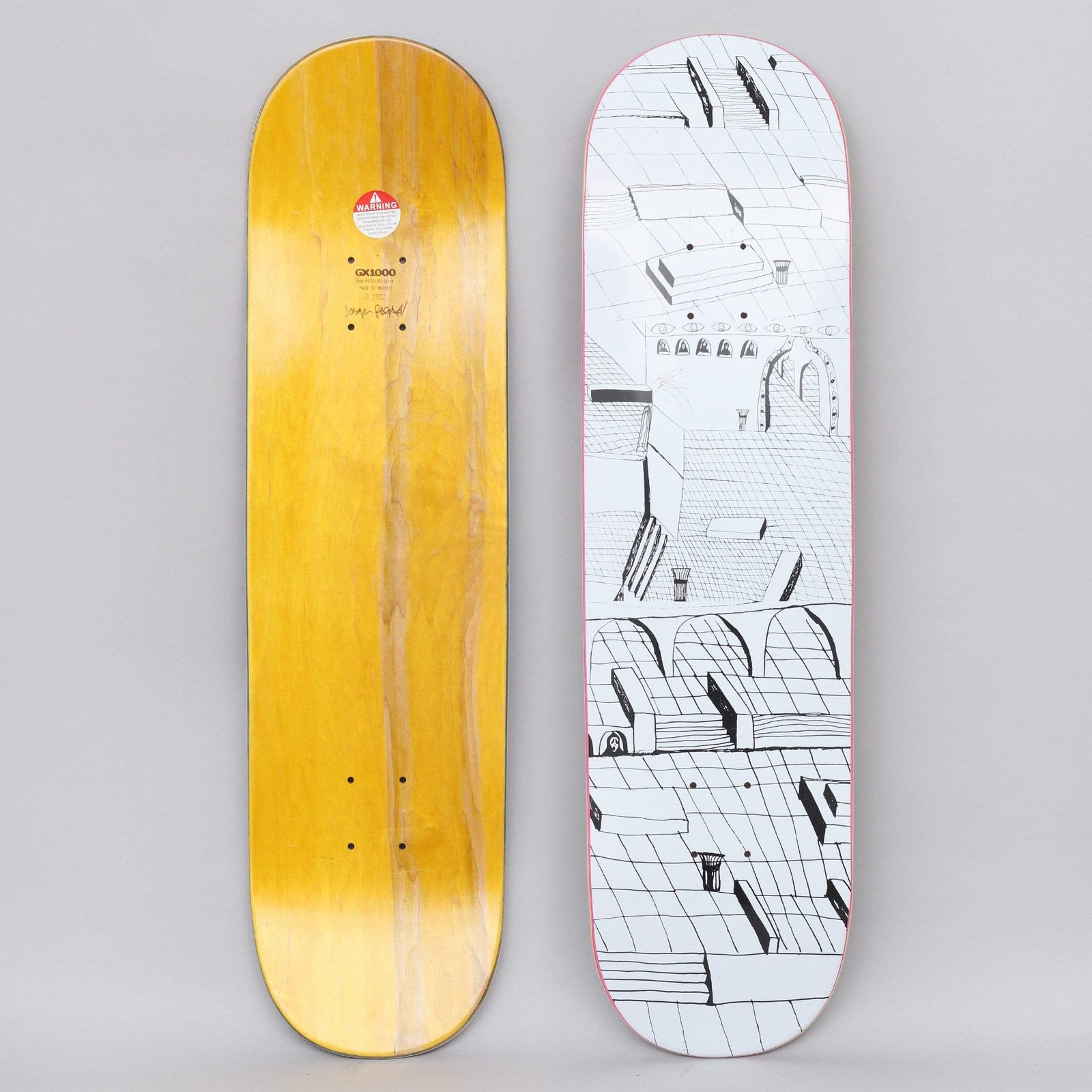 GX1000 Joe Sticker White skateboard deck: Black line drawing on white of a rambling, tiled townscape of rooftops, arches, steps and ledges seen from above. The yellow underside has a small warning label and a signature.