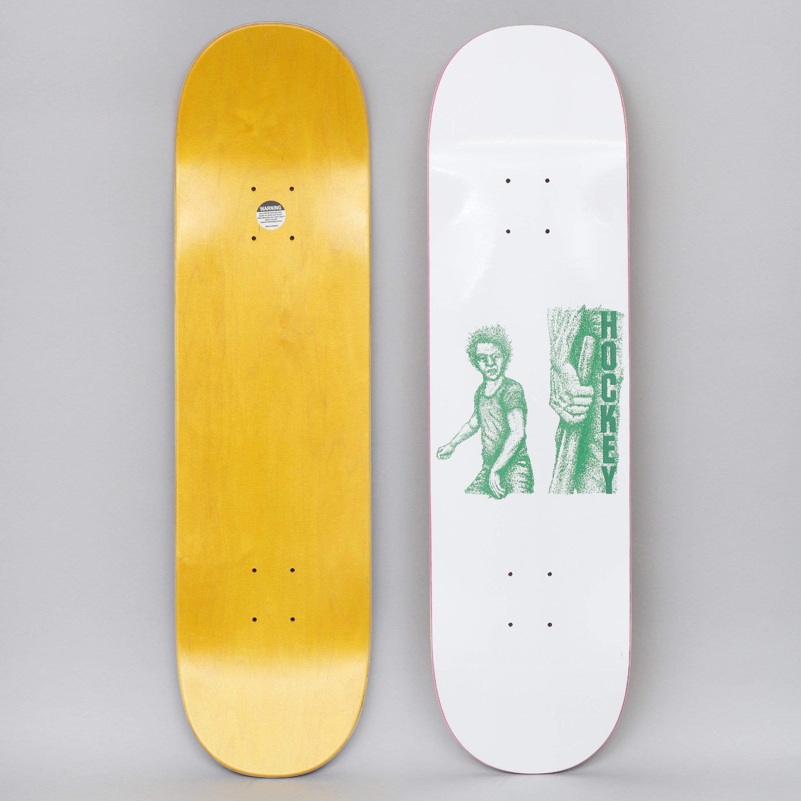 Hockey Battery White skateboard deck: White deck with a green stippled illustration of a scowling young man with spiky hair beside a clenched hand gripping a bat, with HOCKEY in vertical lettering. A yellow stained underside is also shown.