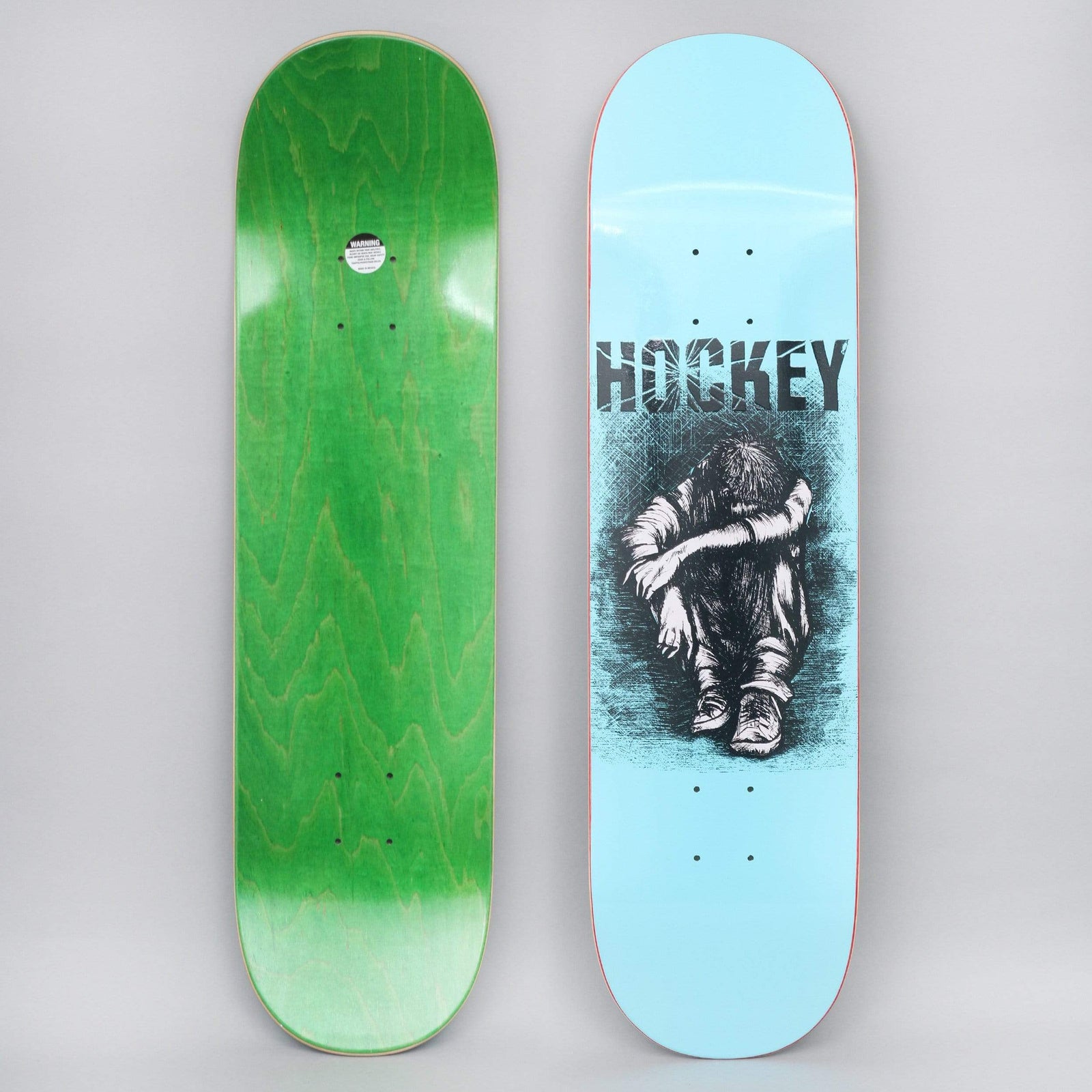 Hockey Missing Kid Blue skateboard deck: Light blue deck with the Hockey name in a cracked black typeface above a crosshatched pen drawing of a dishevelled child sitting hunched with their head down on their knees.