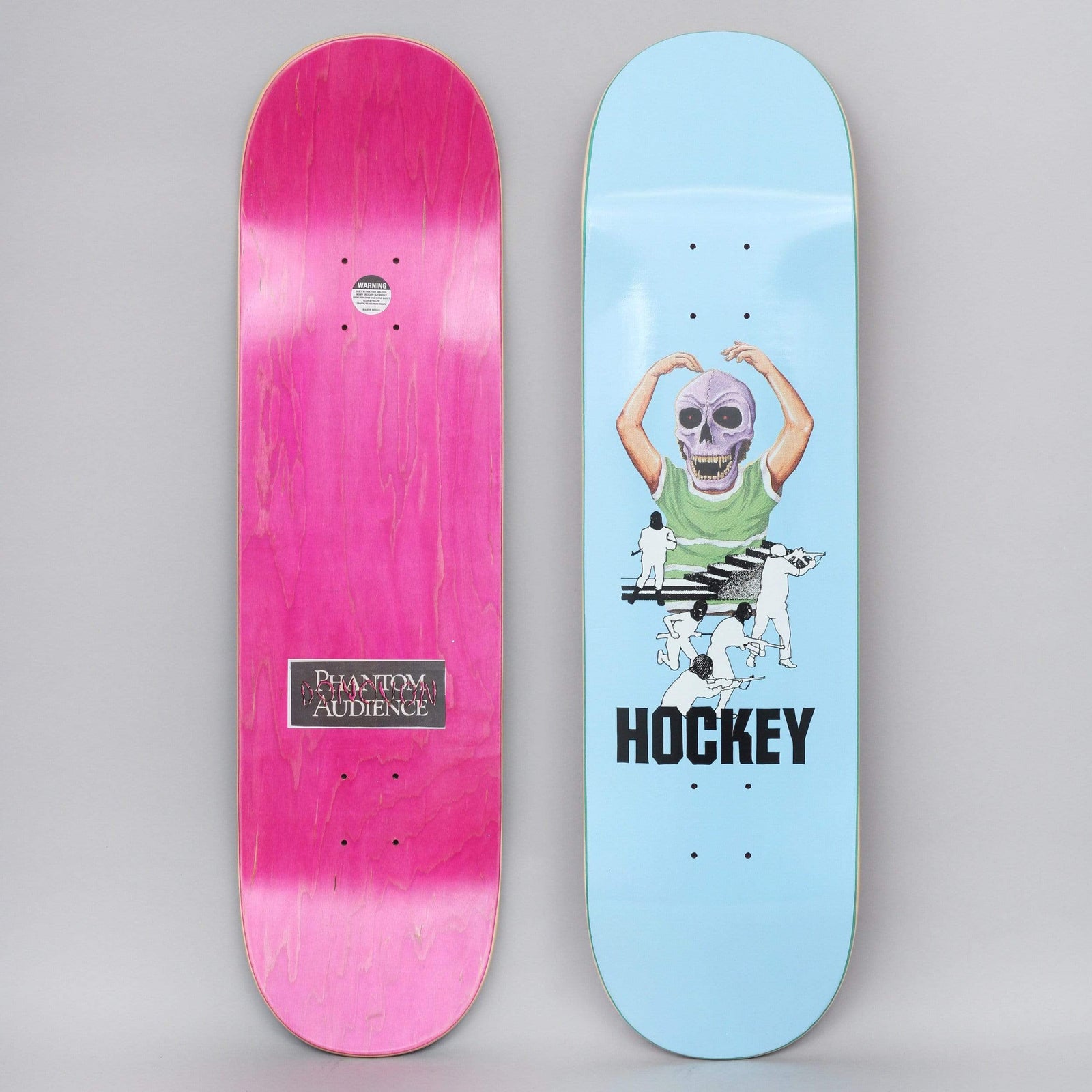 Hockey Donovon Piscopo Skull Kid Blue skateboard deck: Pale blue deck showing a figure in a green top with a purple skull head, arms raised like a ballet dancer, above small black-and-white figures chasing across a staircase. Brand name in black below. Underside has a pink stain and label.