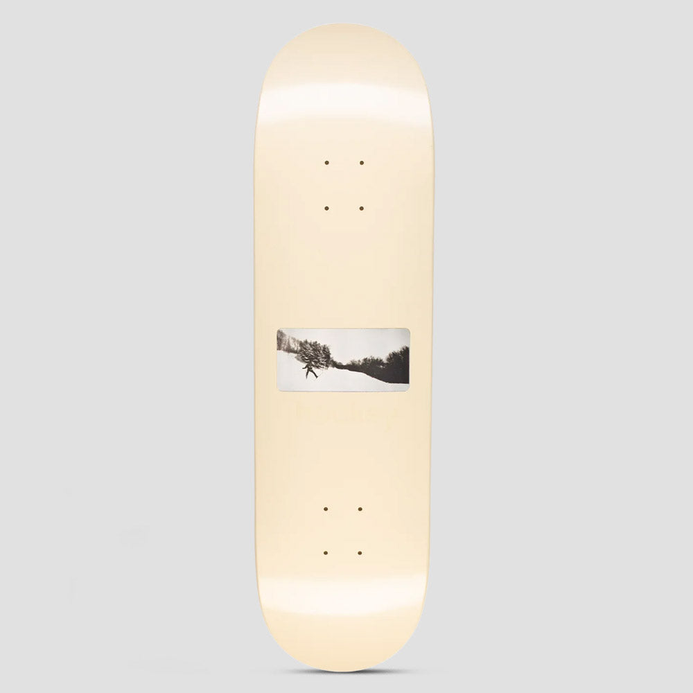 Hockey Take Off Nik Stain Board Shape 1 skateboard deck: A cream deck with a single small black and white photograph in the middle showing a figure in a snowy landscape with trees. Very faint text sits just below the image.